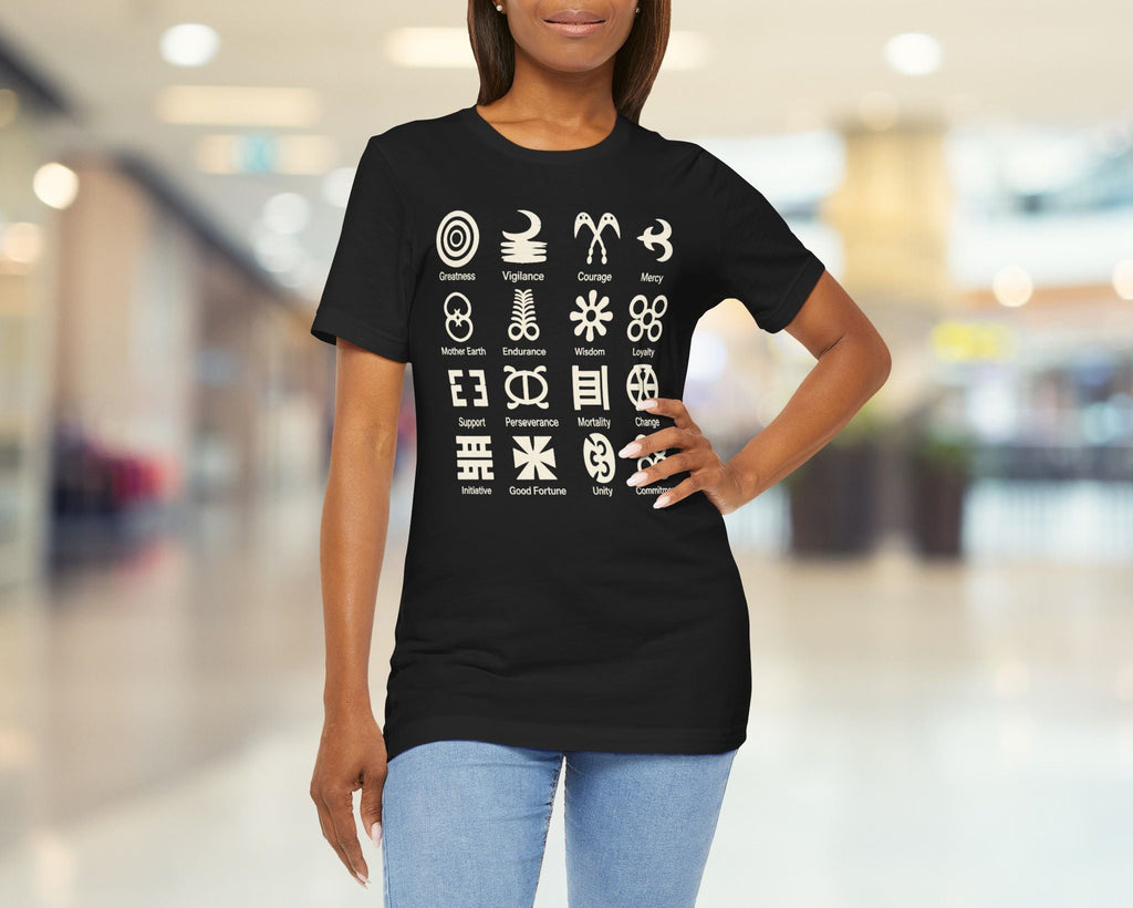 Woman wearing a black t-shirt with white symbols in a blurred indoor setting