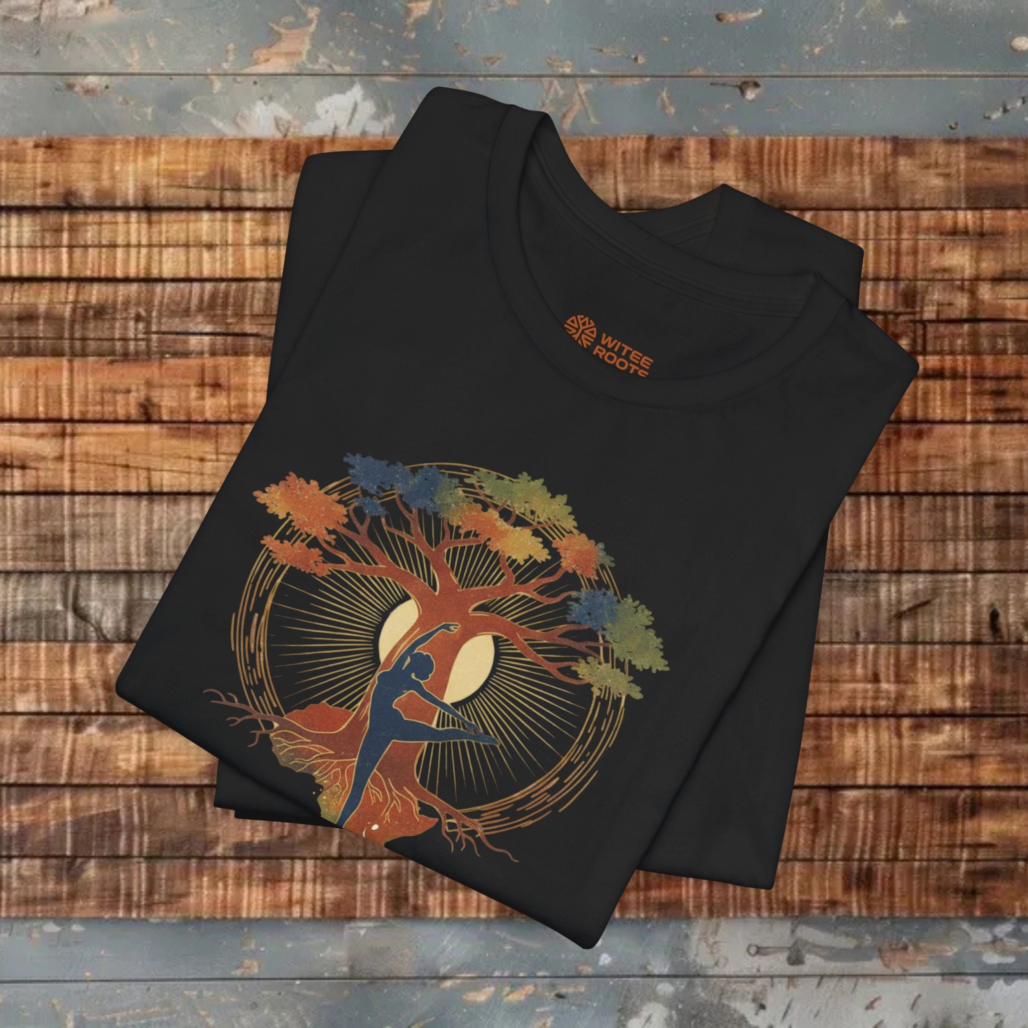 Black t-shirt with a colorful graphic design on a wooden surface