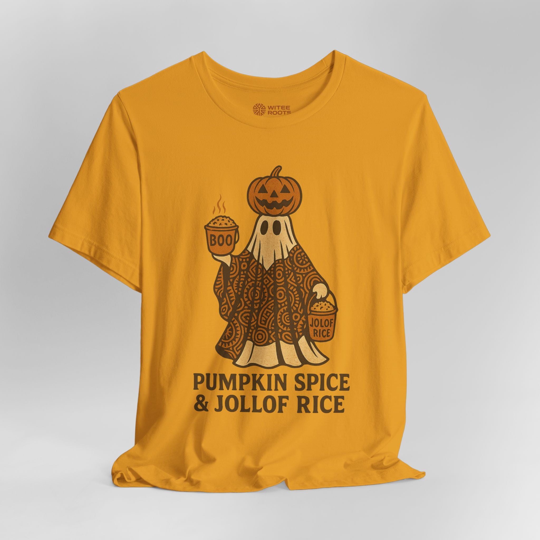 A mustard yellow t-shirt with a Halloween graphic of a ghost in a paisley pattern wearing a pumpkin head and holding a pumpkin spice latte and a bucket labeled 'Jollof Rice'. Below the graphic, the text 'PUMPKIN SPICE & JOLLOF RICE' is printed in black.