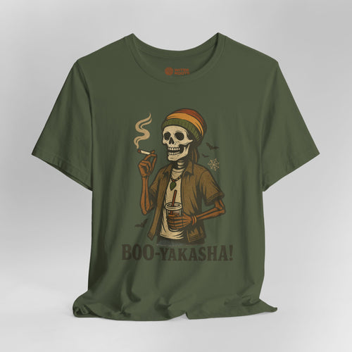 An olive green short-sleeve t-shirt with a graphic of a skeleton wearing a Rasta hat and holding a cigar and a drink, with the text 'BOO-YAKASHA!' printed below. The shirt is shown on a neutral gray background.