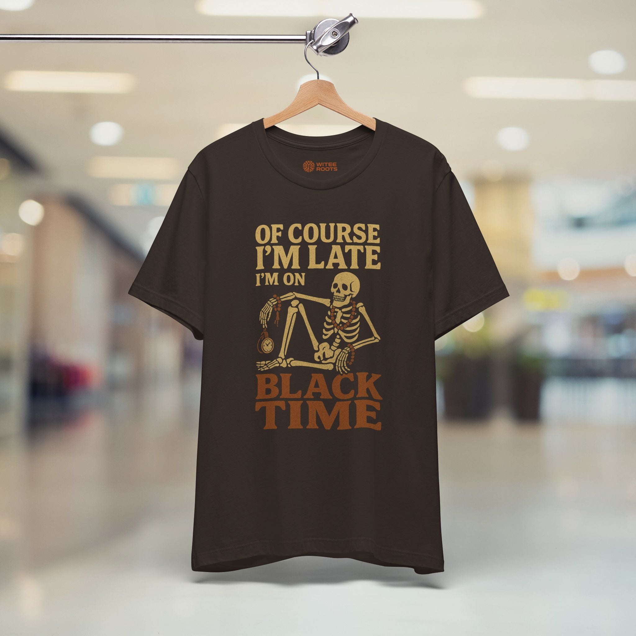 Brown  t-shirt with 'Diverse by Design' text on a hanger in a store.