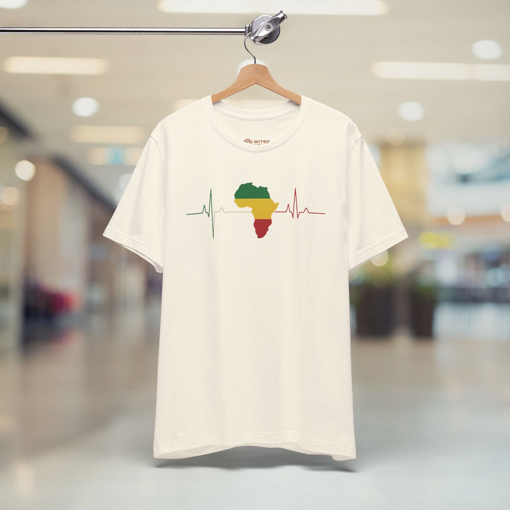 Beige t-shirt with a graphic design on a hanger in a store setting