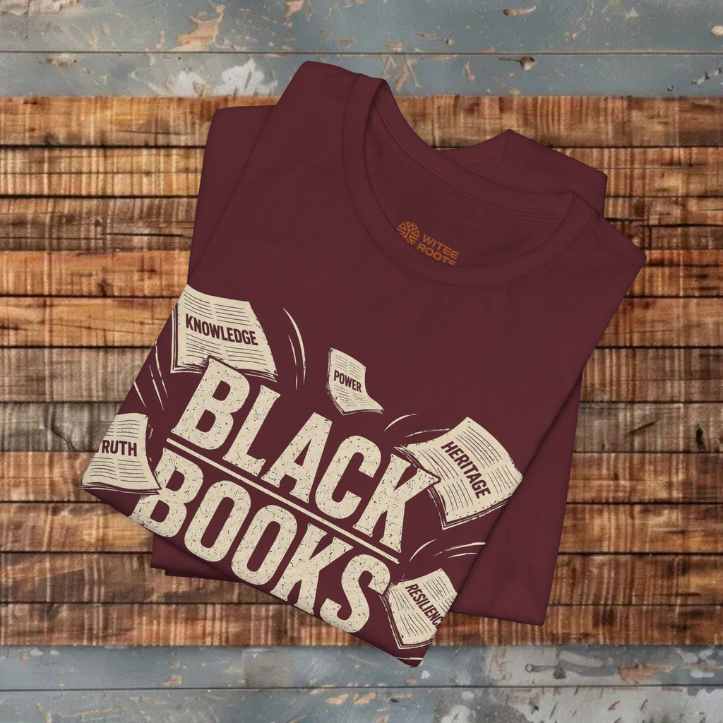 Maroon t-shirt with 'Black Books' design on a wooden surface