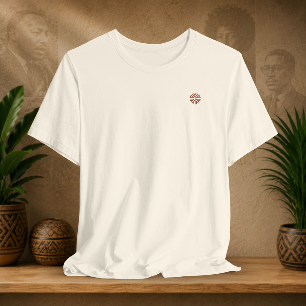 Beige t-shirt with a printed message on a wooden surface with plants and a blurred background