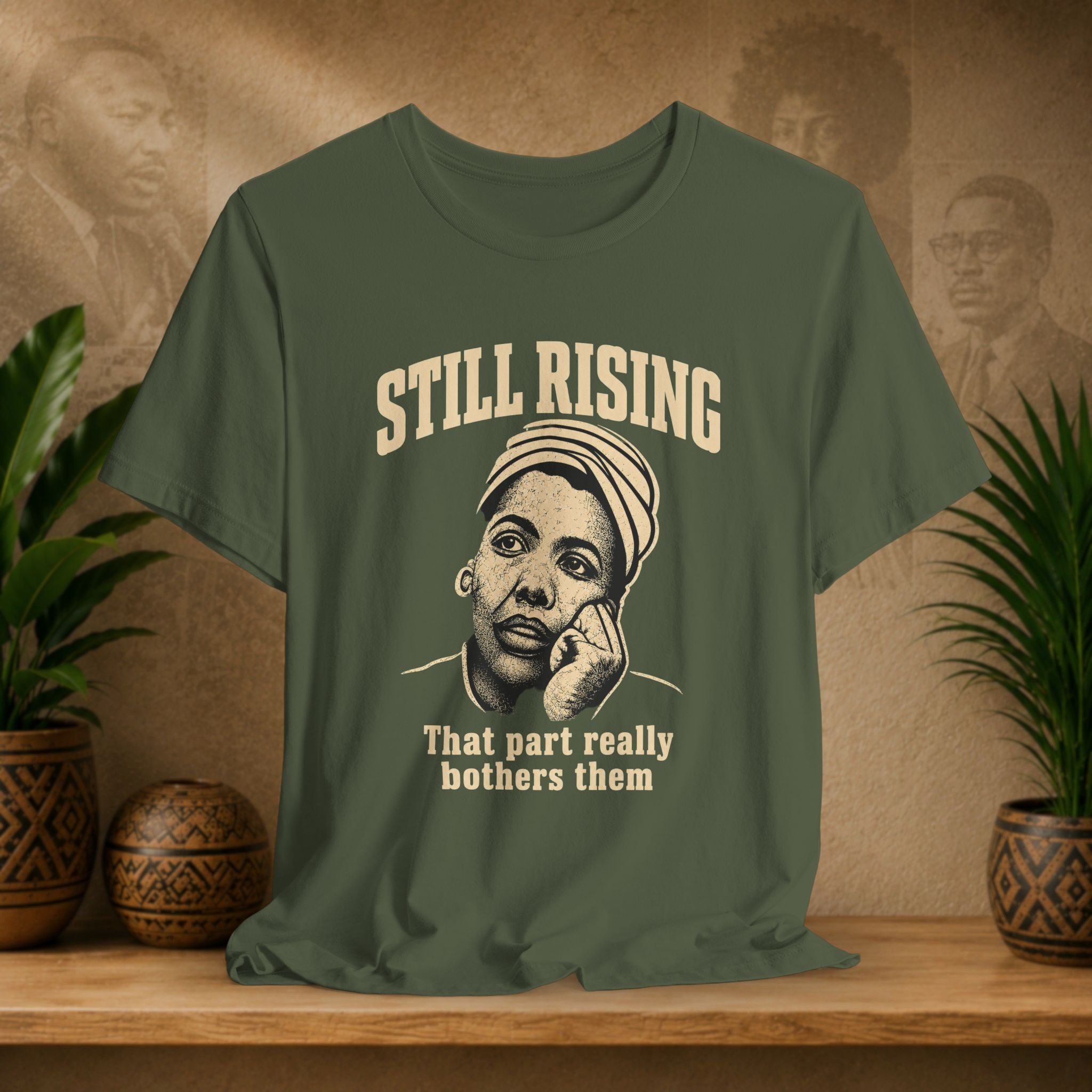 Green t-shirt with graphic and text on a wooden surface with plants and a textured wall background
