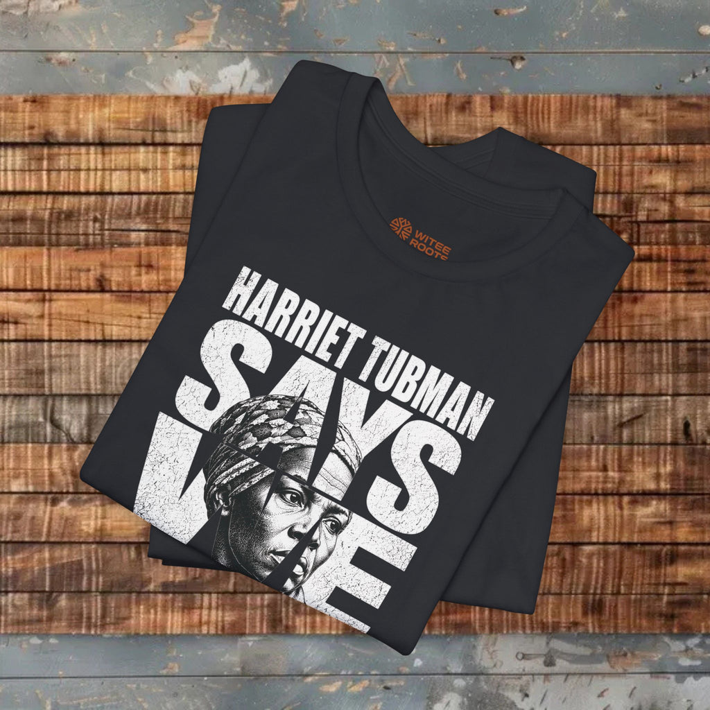 Black t-shirt with 'Harriet Tubman Says Yes' design on a wooden surface