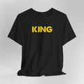 Black t-shirt with 'KING' printed in yellow on a gray background