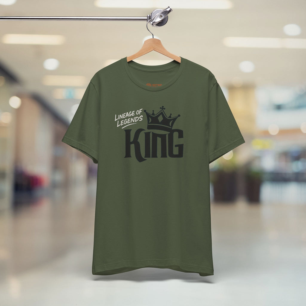 Green t-shirt with 'Lineage of Legends King' text on a hanger in a store setting