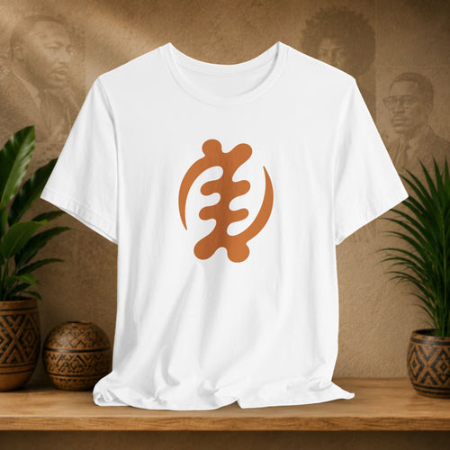 White t-shirt with a brown symbol on a wooden shelf with plants and a textured wall background