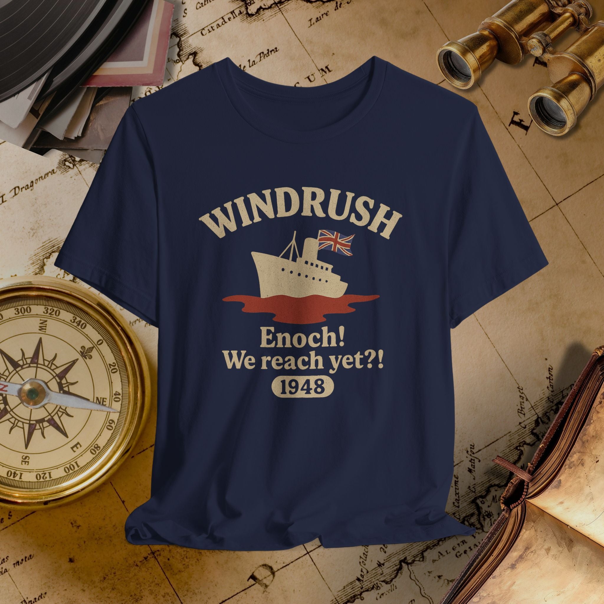 Navy blue t-shirt with 'Windrush' design on a vintage map background
