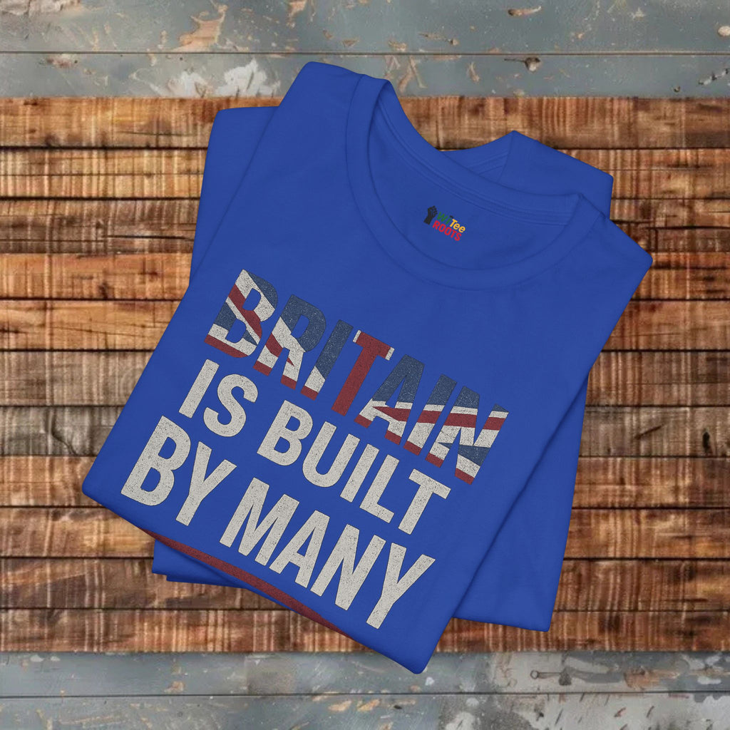 Blue t-shirt with 'Britain is built by many' text on a wooden surface
