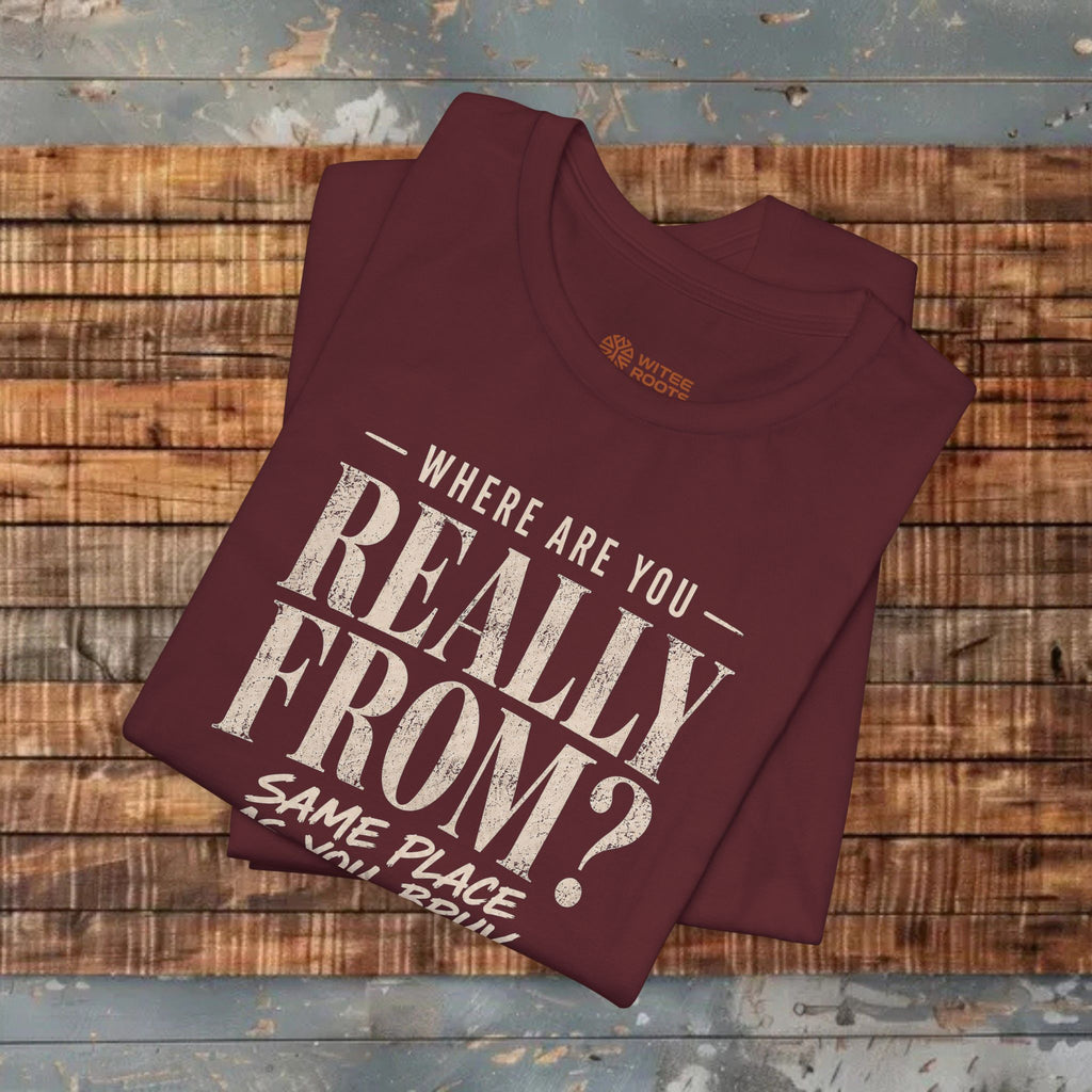 Maroon t-shirt with text on a wooden surface
