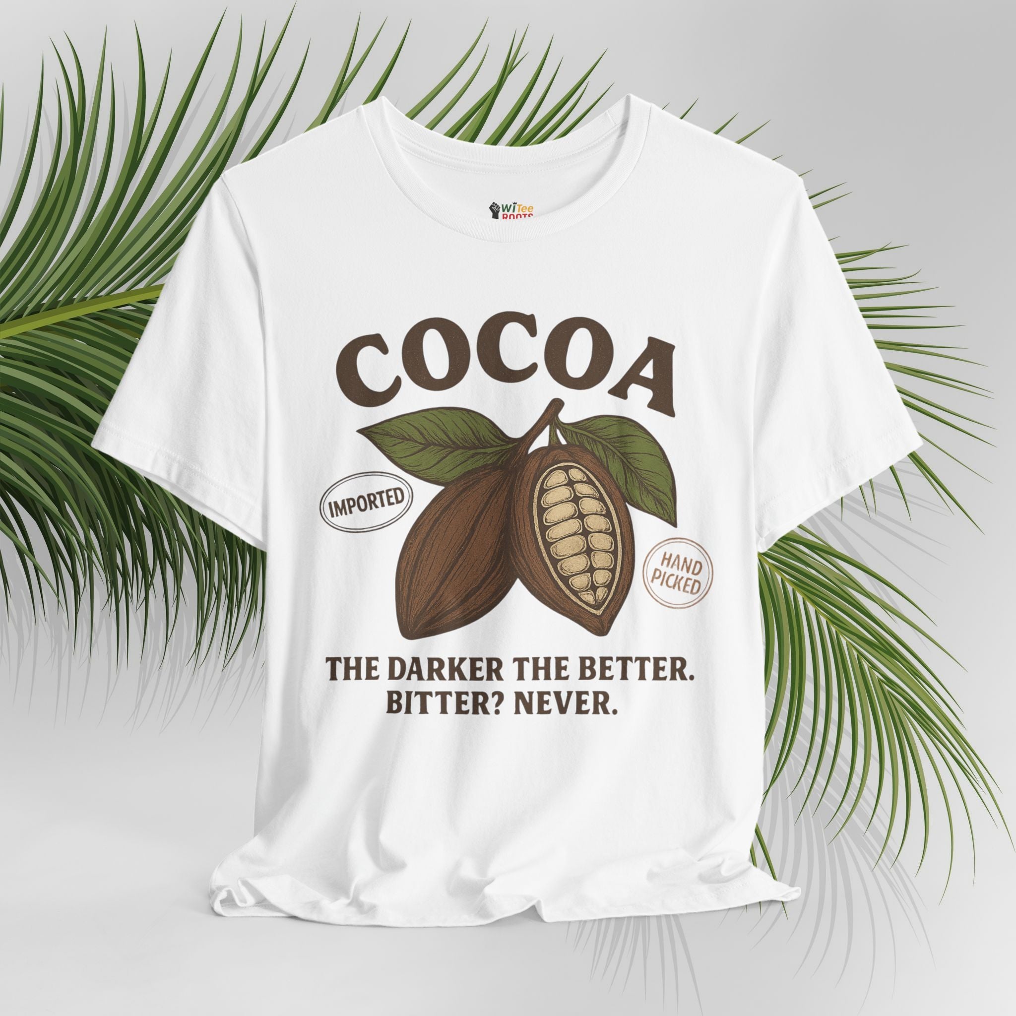 White t-shirt with cocoa graphic and text on a light gray background with green leaves.