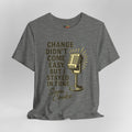 Gray t-shirt with gold microphone graphic and text on a white background