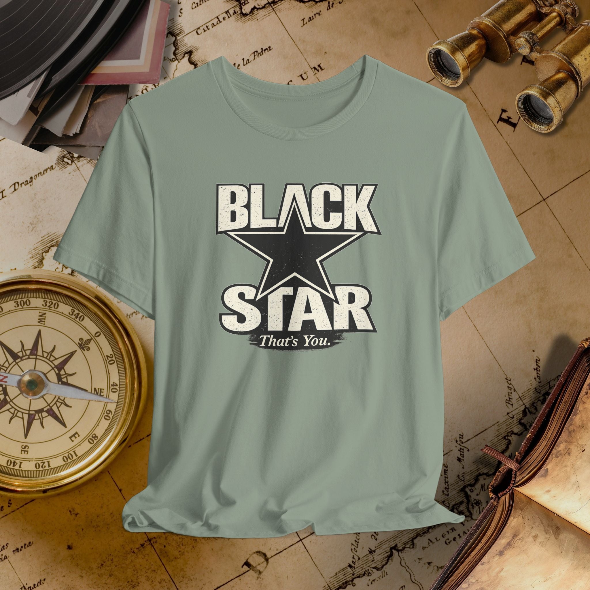 Green t-shirt with 'Black Star That's You' design on a vintage map background