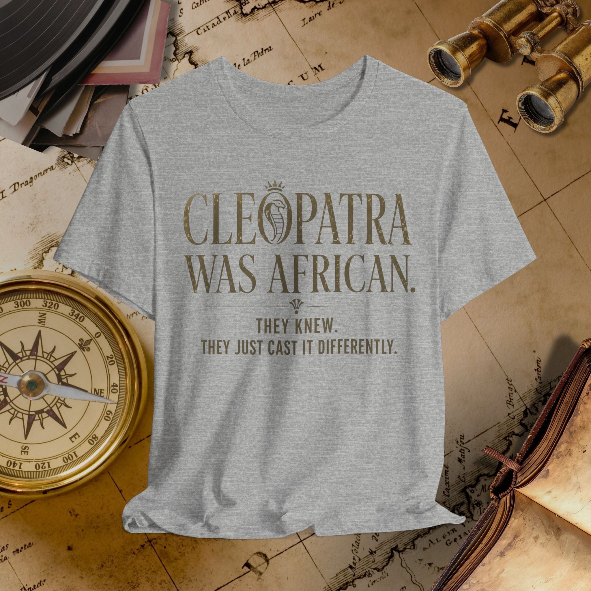 Gray t-shirt with 'Cleopatra Was African' text on a vintage map background