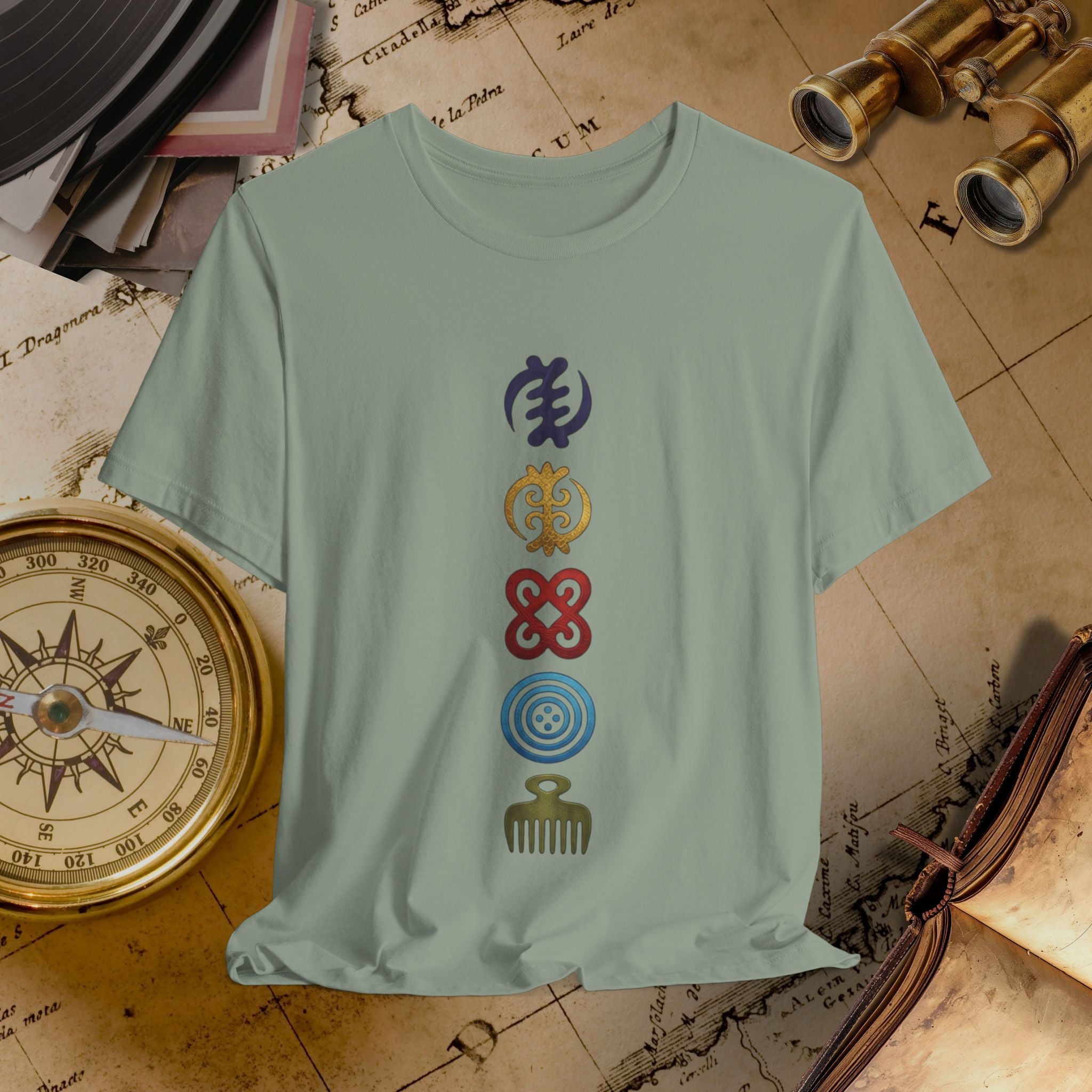 Light green t-shirt with colorful symbols on a vintage map background