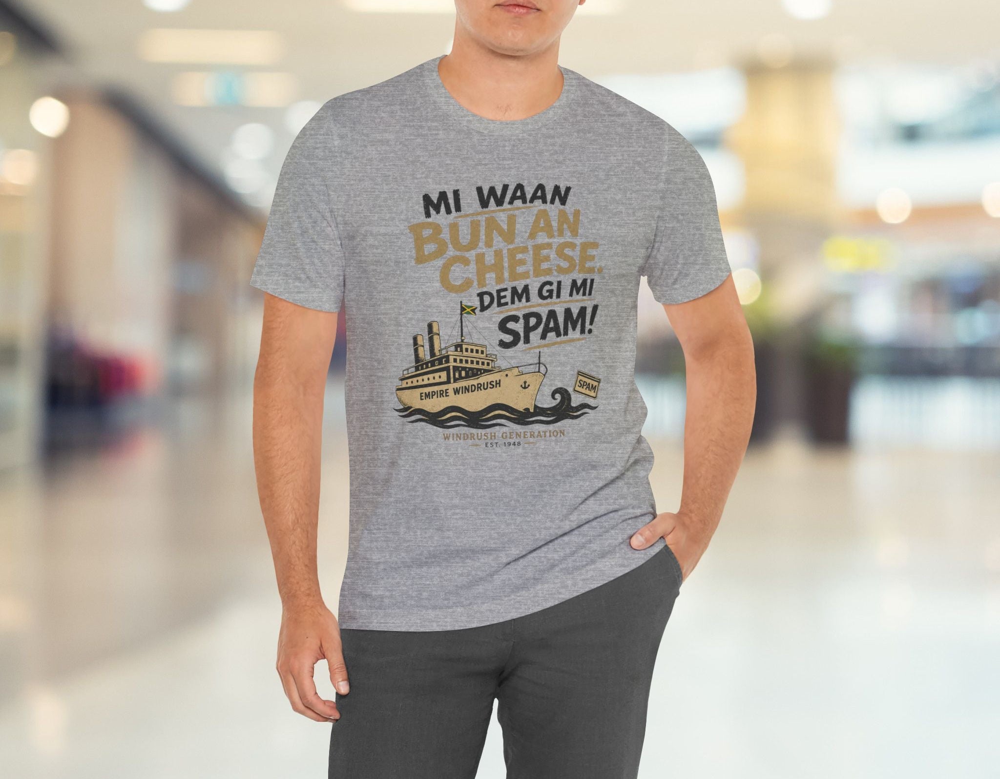 Man wearing a gray t-shirt with a humorous graphic and text in a mall.