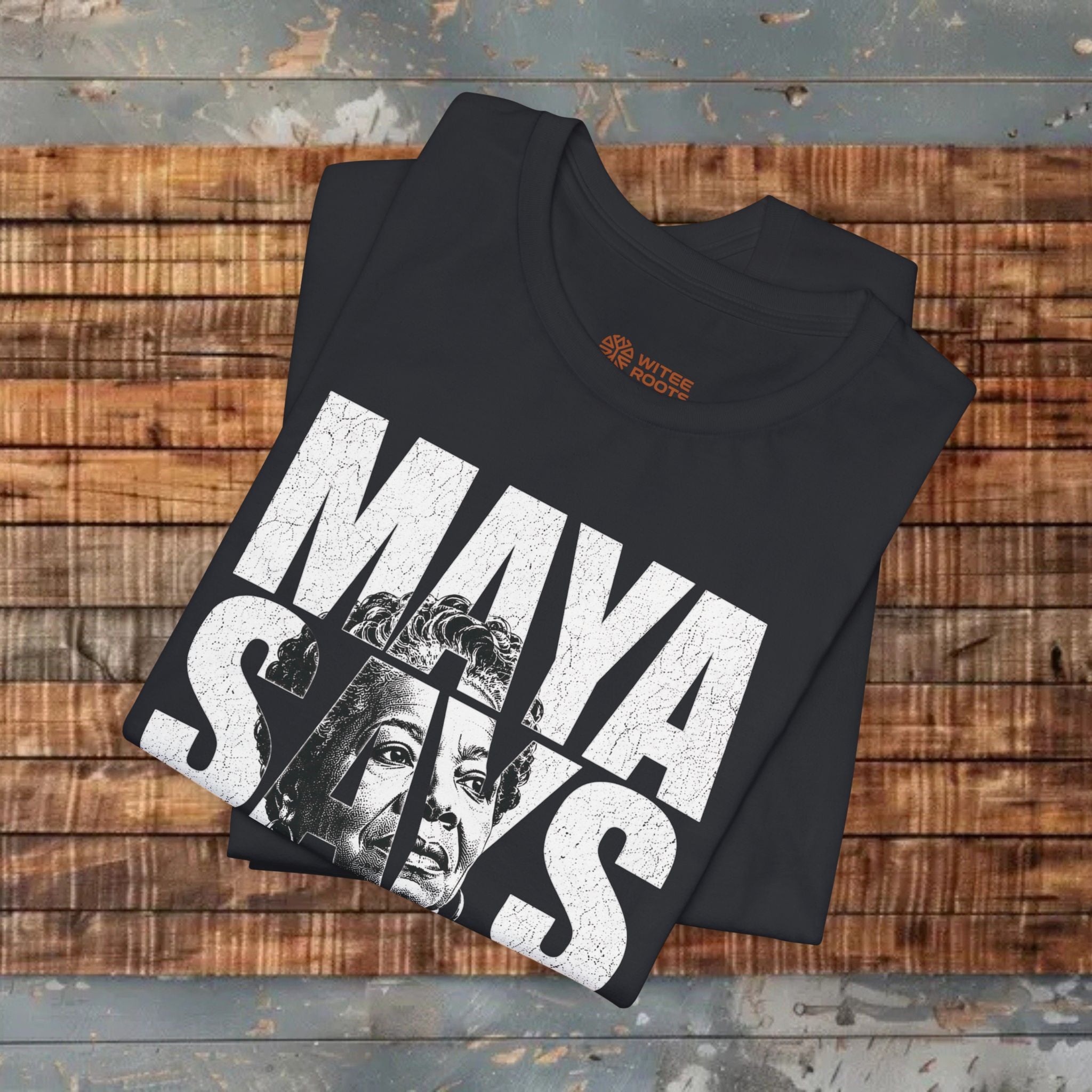 Black t-shirt with 'Maya' graphic design on a wooden surface