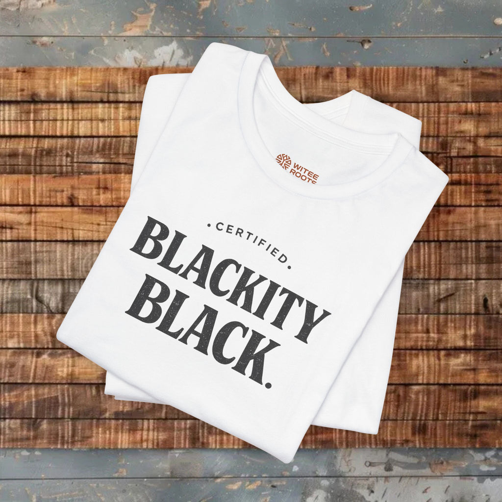 White tank top with 'Certified Blackity Black' text on a wooden surface