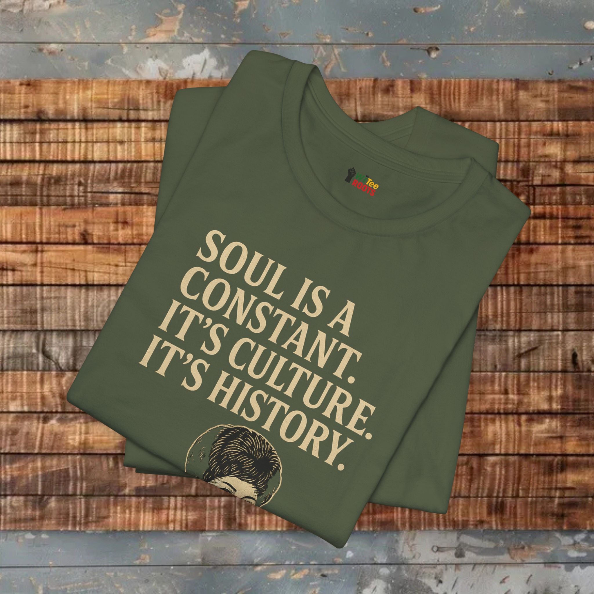 Green t-shirt with text on a wooden surface