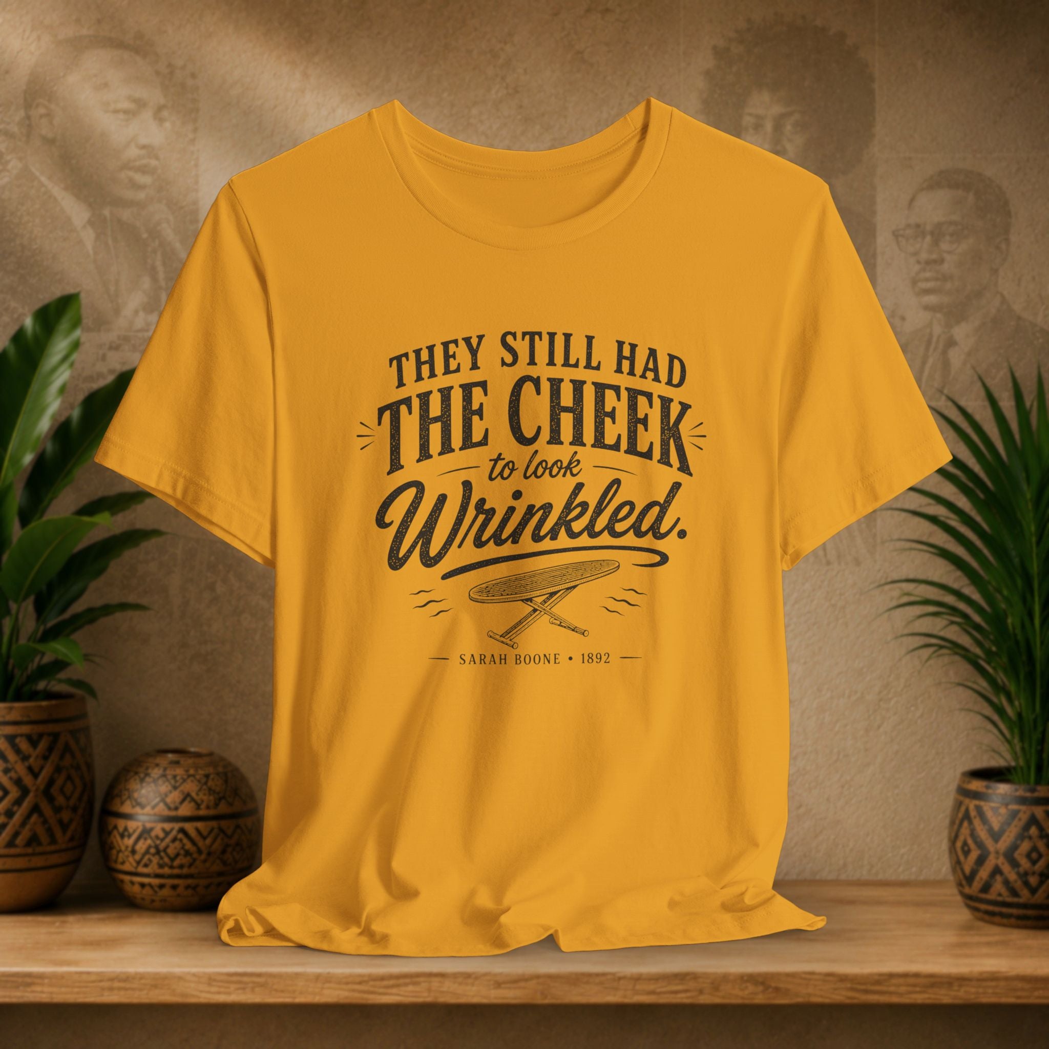 Mustard t-shirt with text on a wooden surface with plants and a vintage-style background