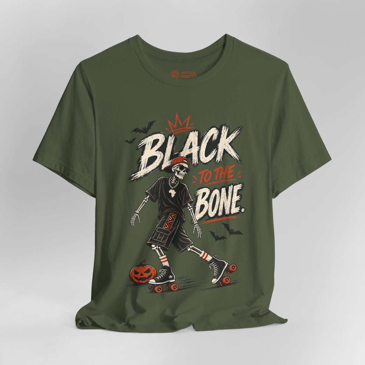 An olive green short-sleeve t-shirt with a graphic print of a skeleton roller skate and the text 'BLACK TO THE BONE' in white and orange, displayed on a neutral gray background.