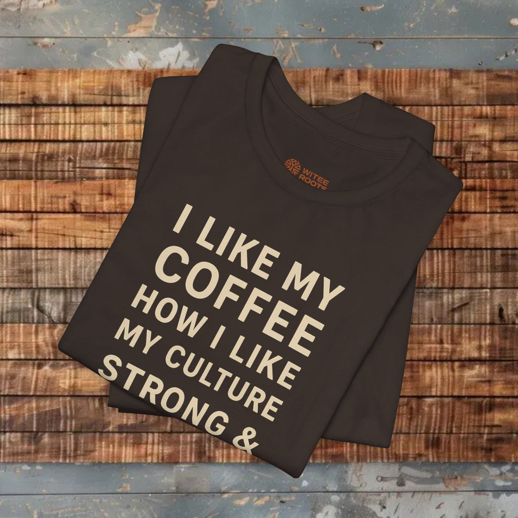 Folded black t-shirt with text on a wooden surface