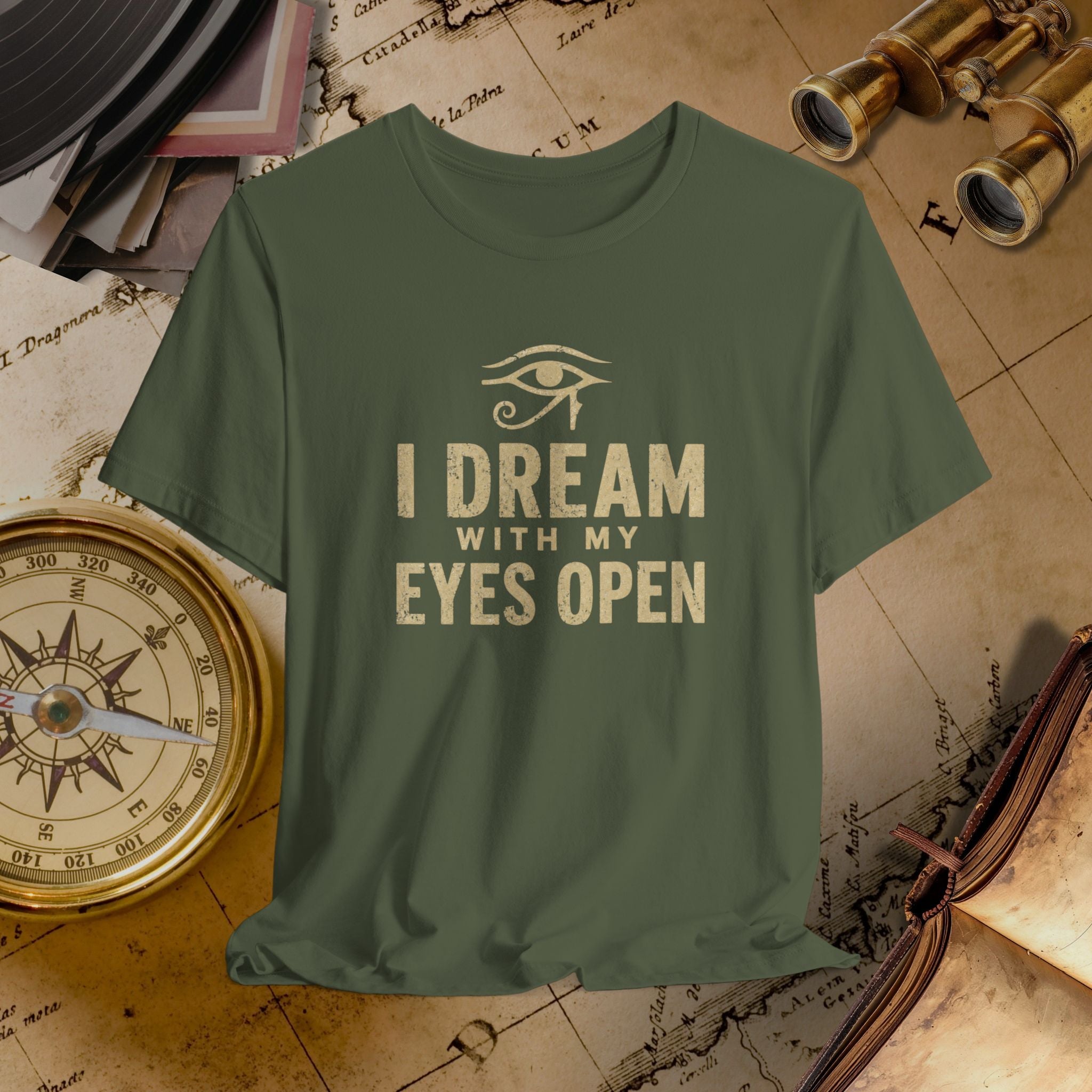 Green t-shirt with 'I Dream with My Eyes Open' text on a vintage map background