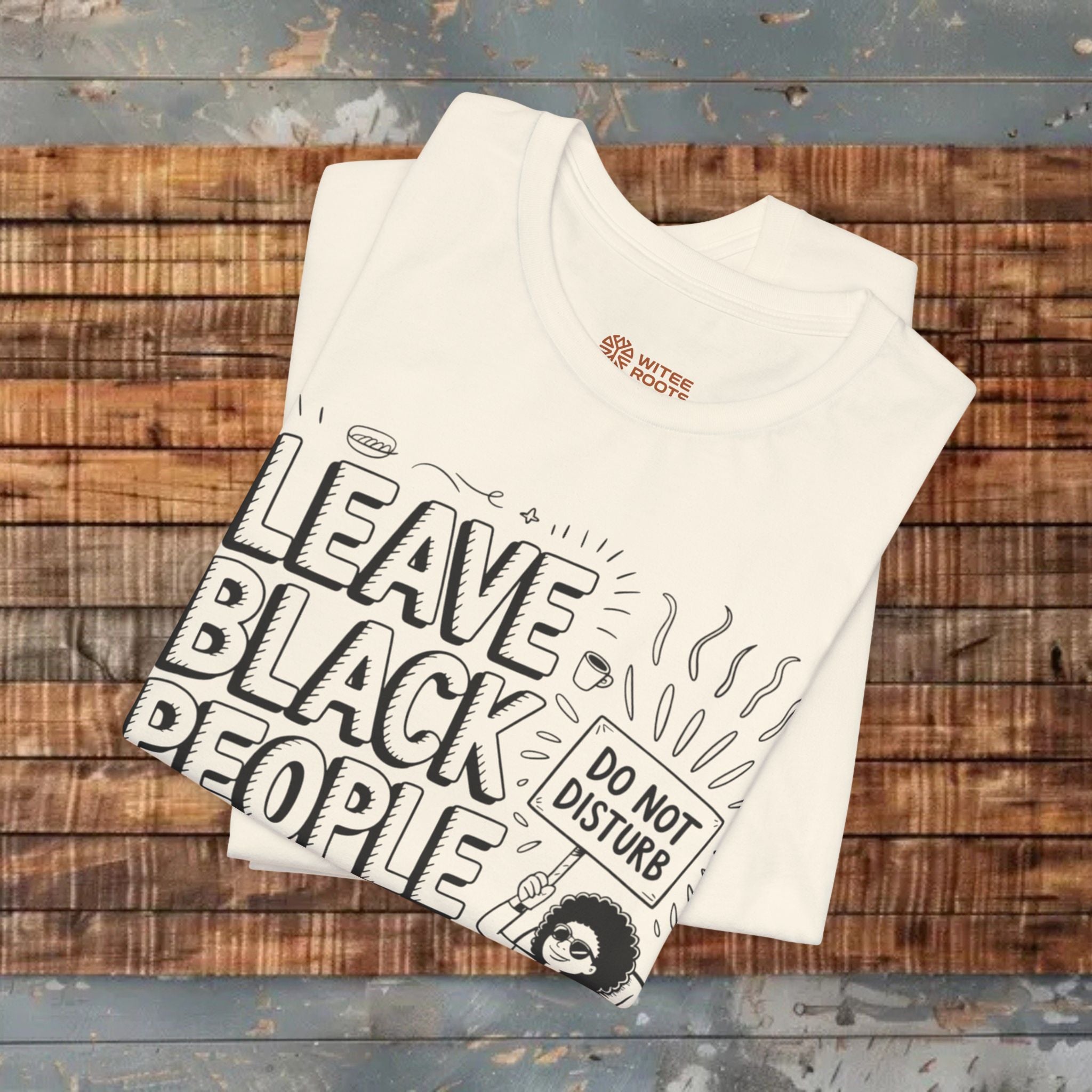 Cream t-shirt with graphic design on a wooden surface