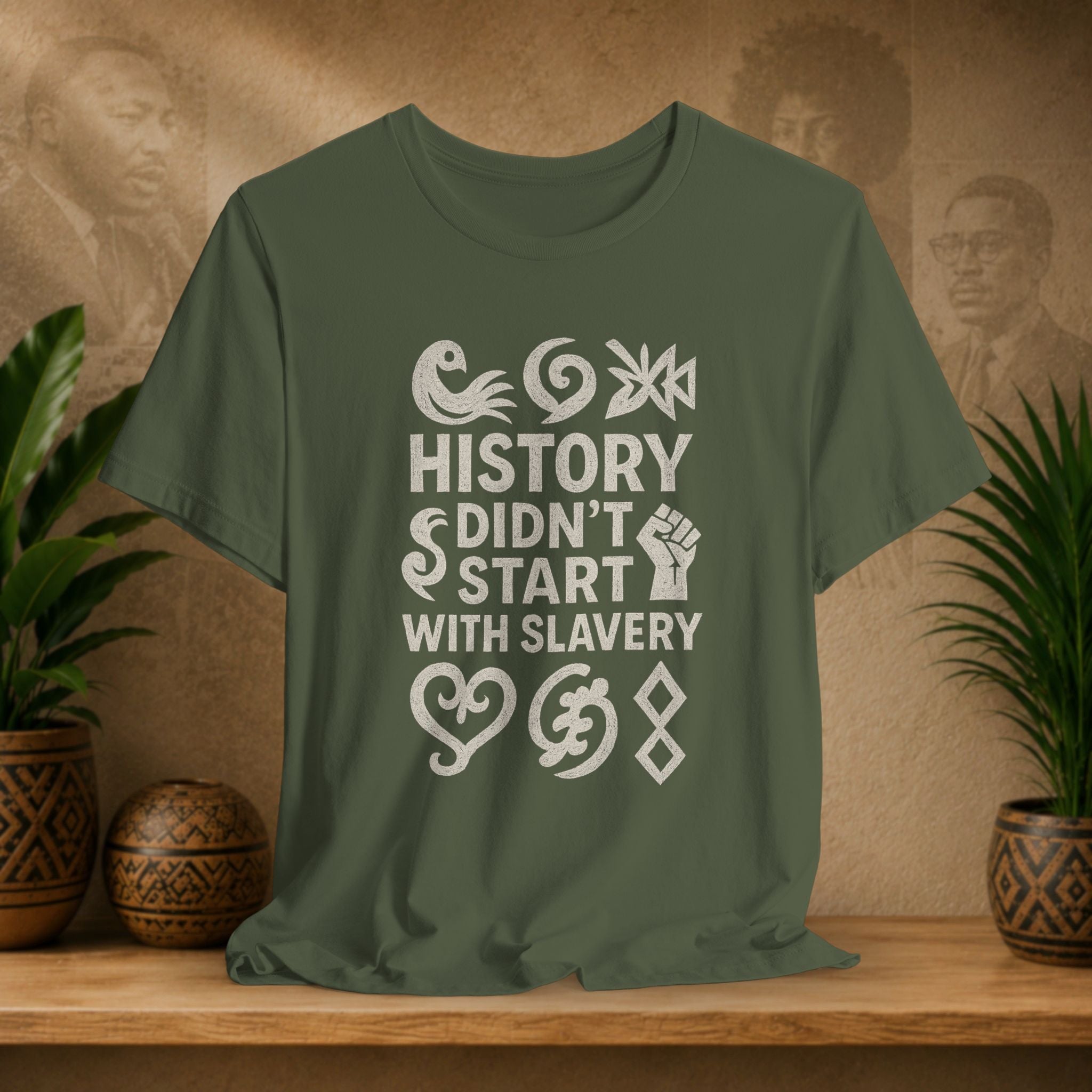 Green t-shirt with white text and symbols on a wooden surface with a decorative background.