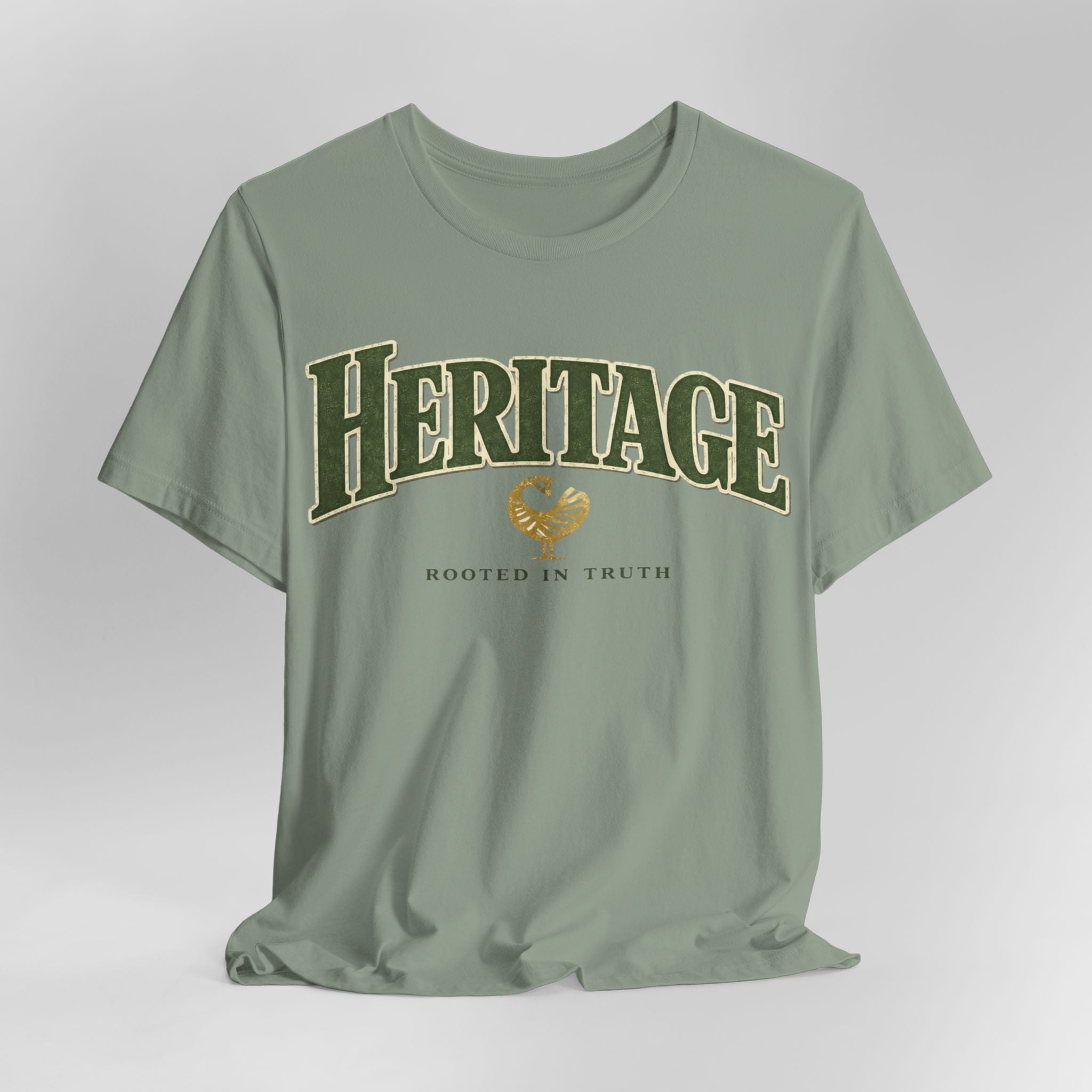 Green t-shirt with 'Heritage Rooted in Truth' text on a light gray background