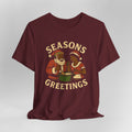 Maroon t-shirt with 'Seasons Greetings' graphic on a white background