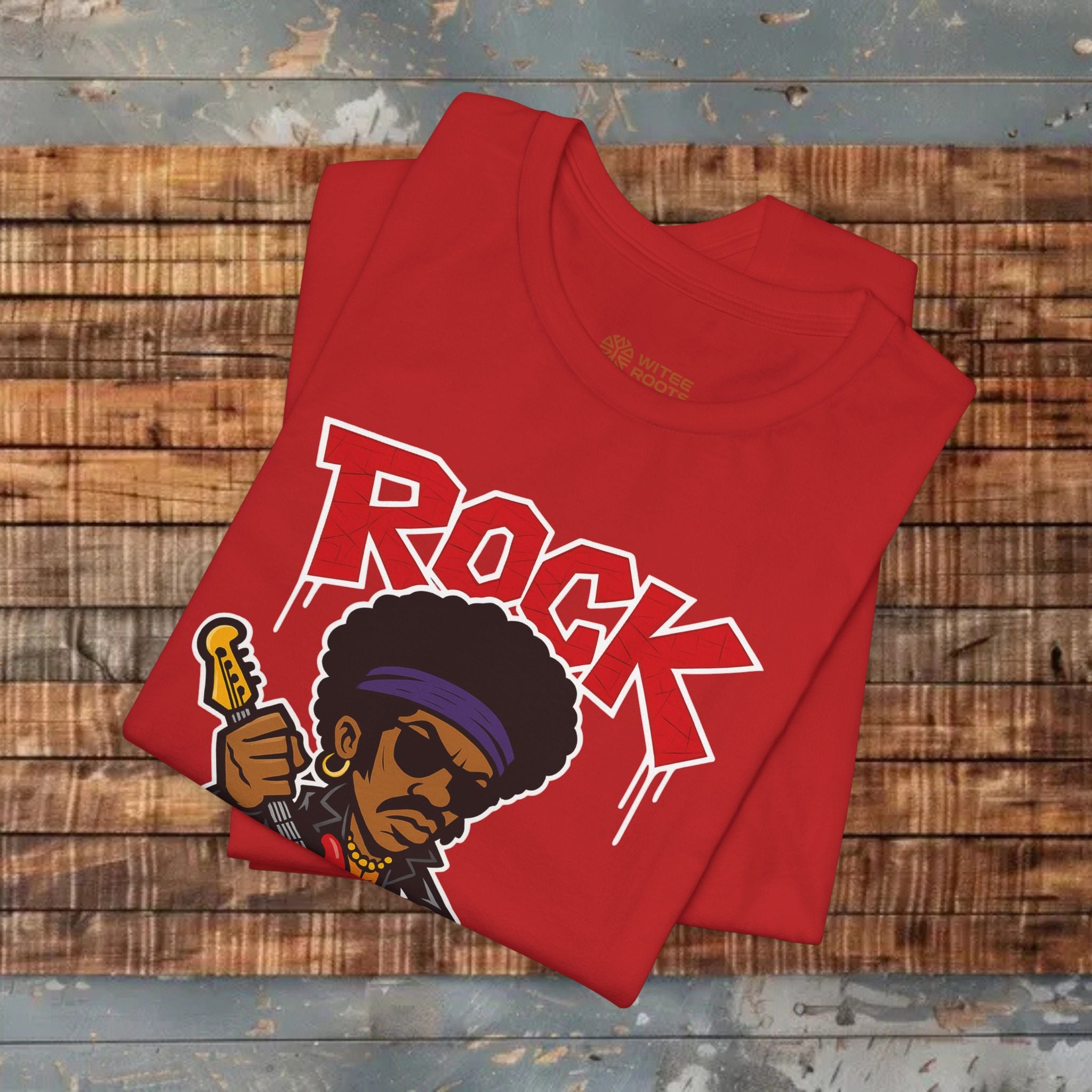 Red t-shirt with 'Rock' design on a wooden surface