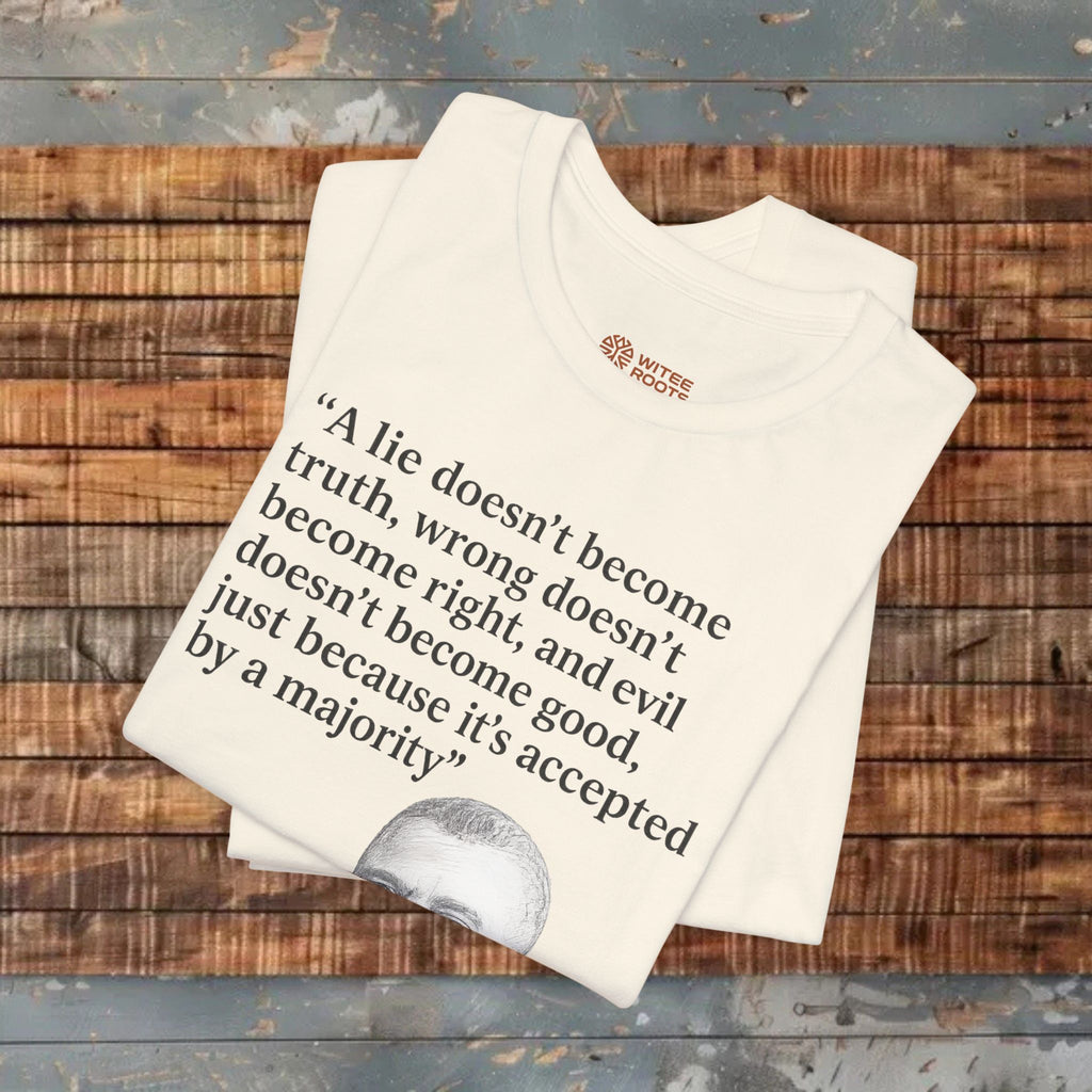 Folded white t-shirt with text and logo on a wooden surface