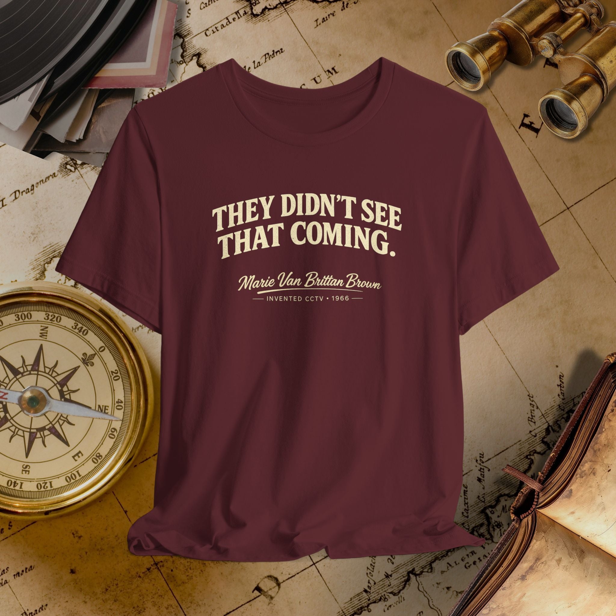 Maroon t-shirt with text on a vintage map background