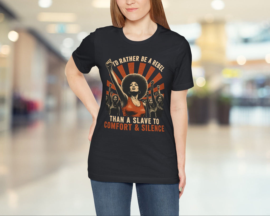Woman wearing a black t-shirt with a graphic design and text in a blurred indoor setting