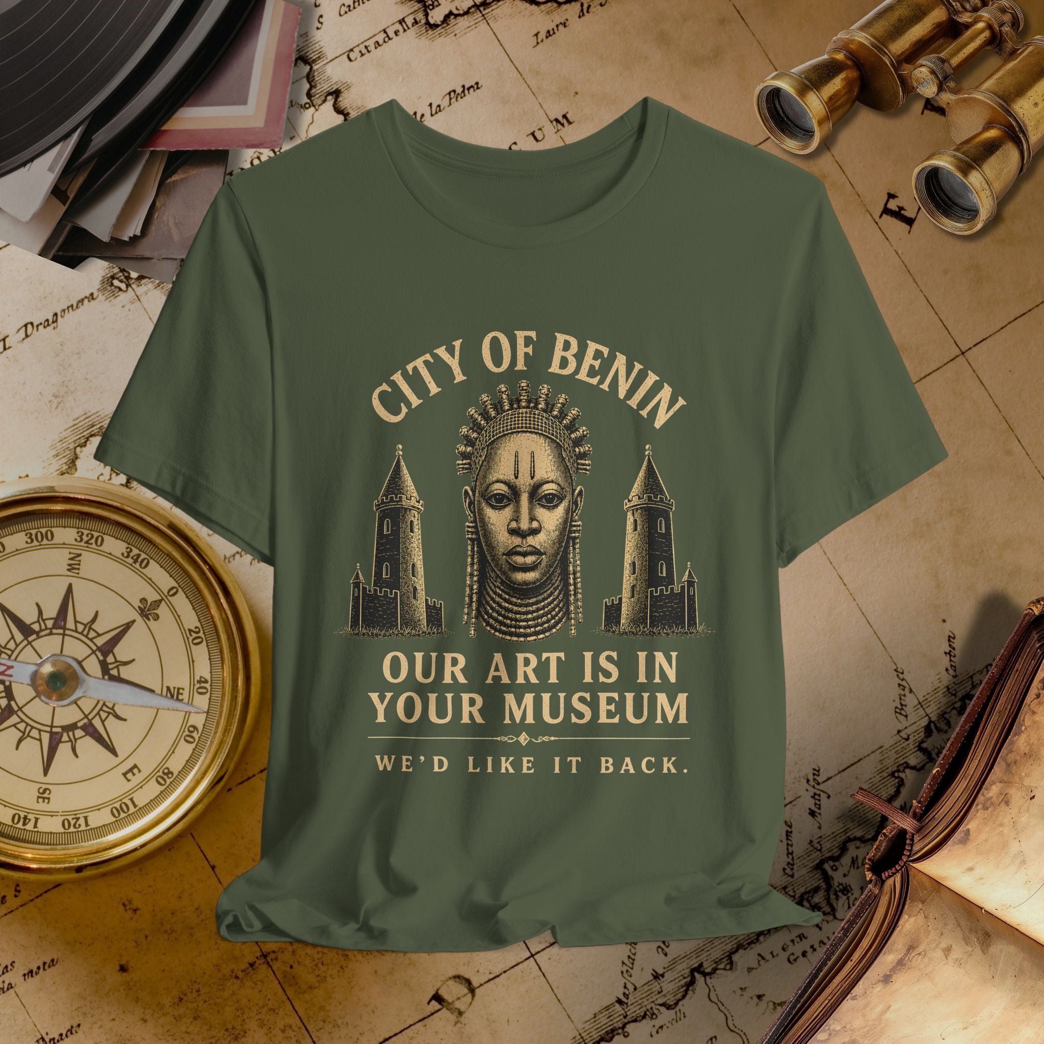Green t-shirt with graphic design and text on a vintage map background
