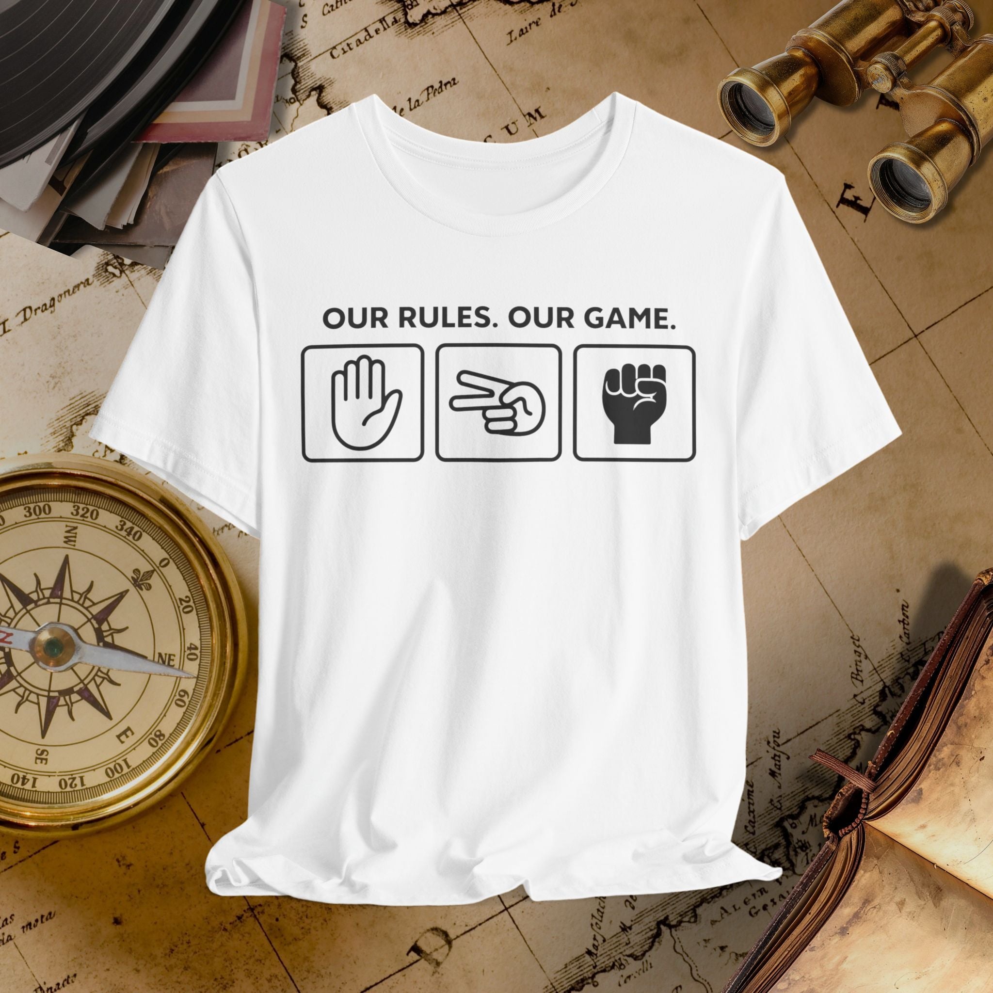 White t-shirt with 'Our Rules, Our Game' text and symbols on a vintage map background