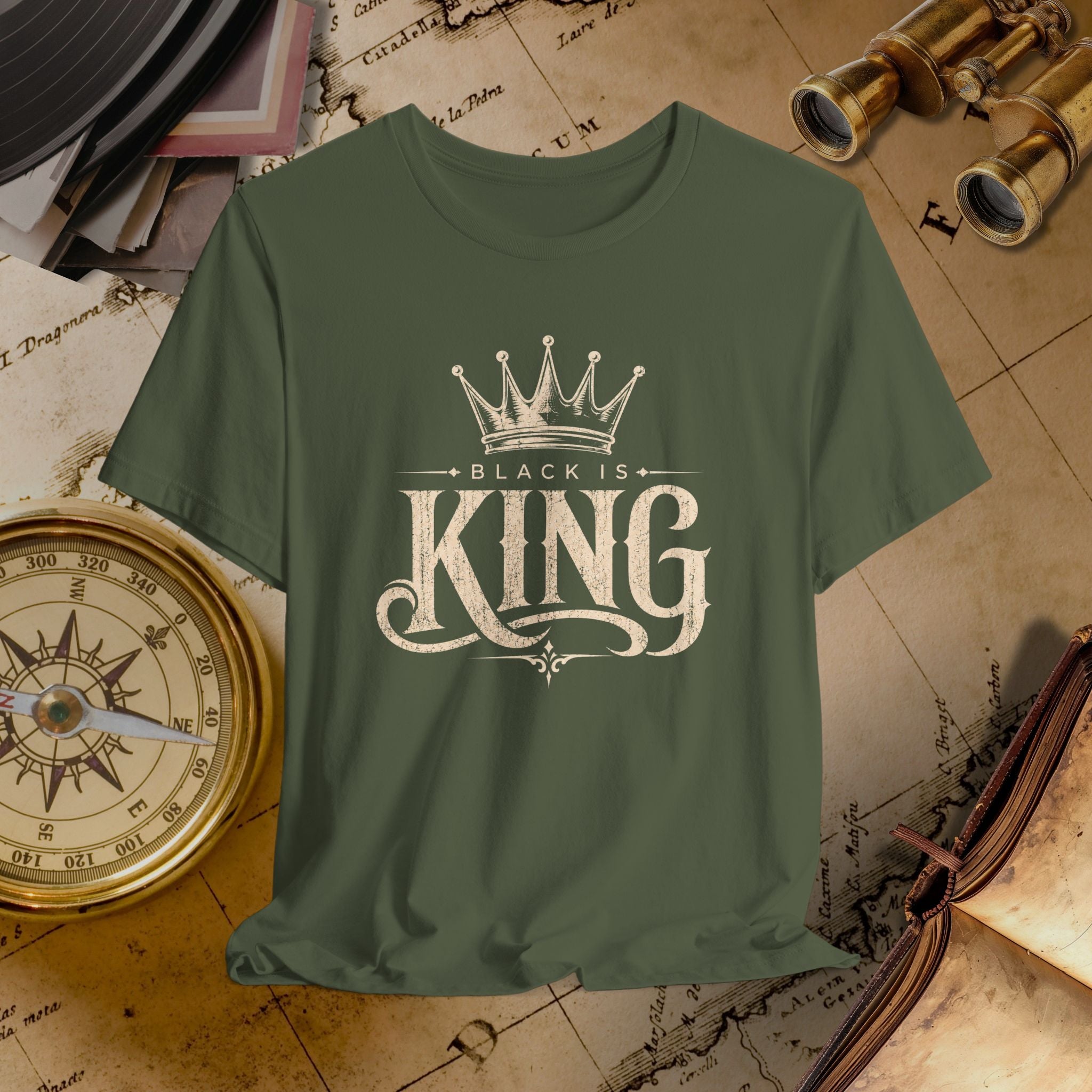 Green t-shirt with 'Black is King' design on a vintage map background