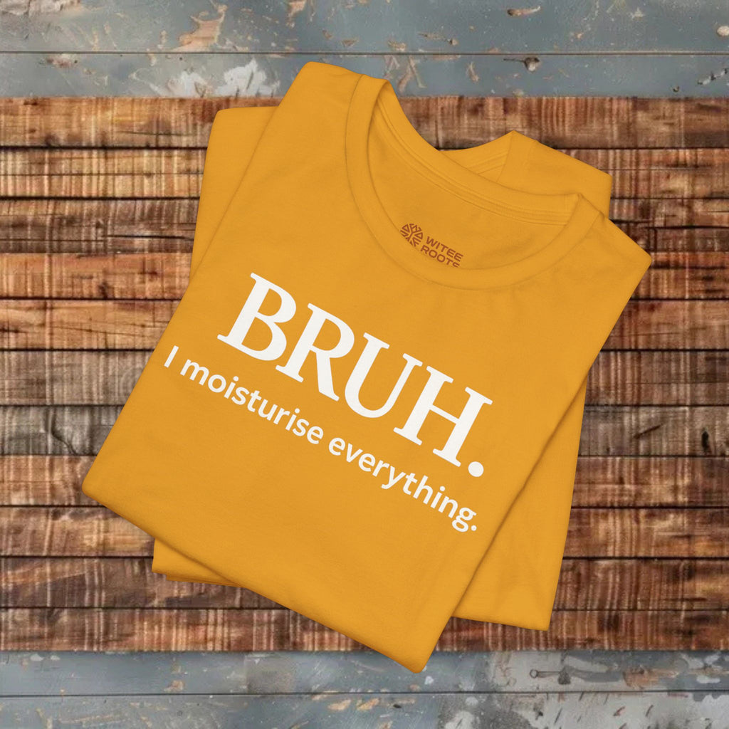 A folded mustard yellow t-shirt with white text reading 'BRUH. I moisturise everything.
