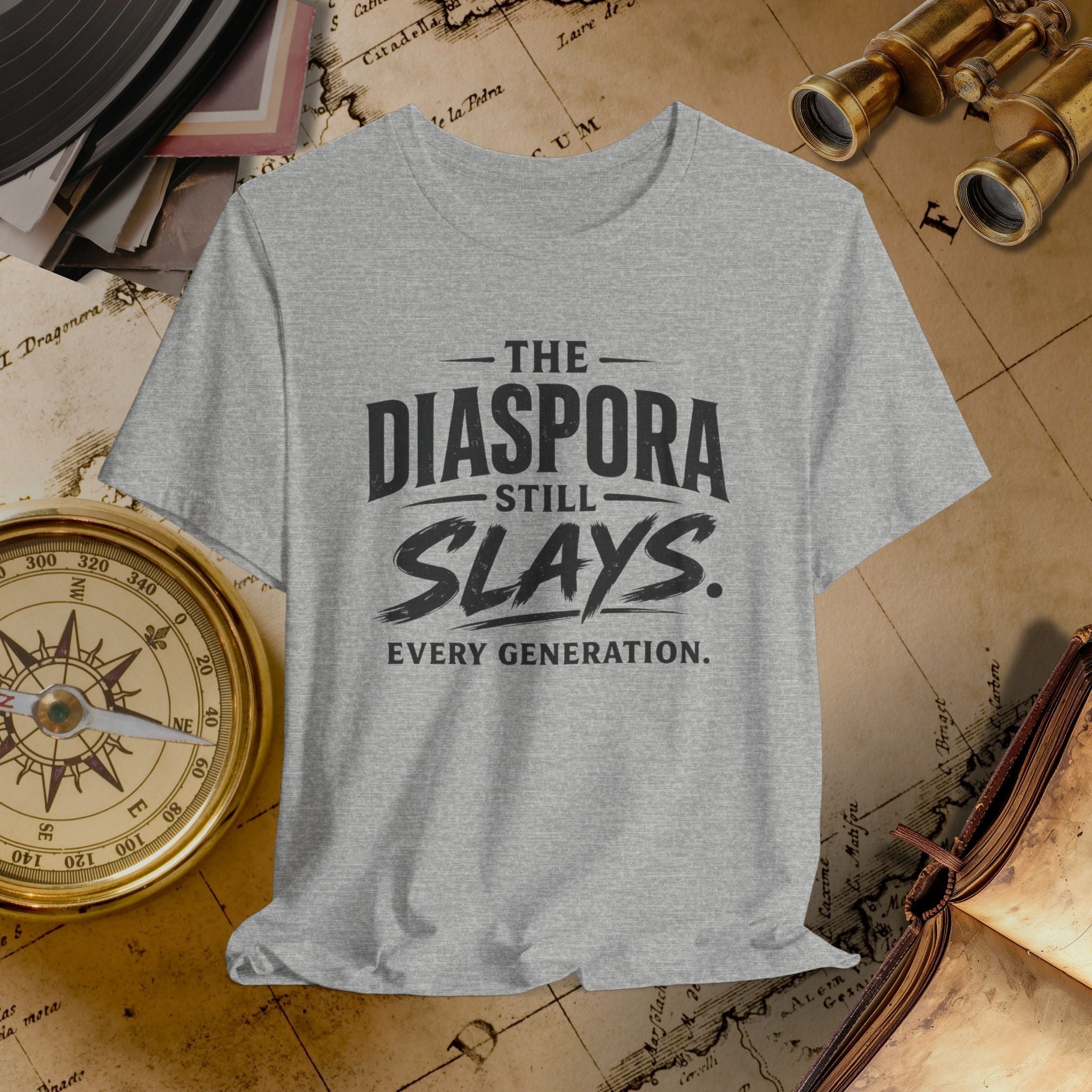 Grey t-shirt with 'The Diaspora Still Slays Every Generation' text on a vintage map background.