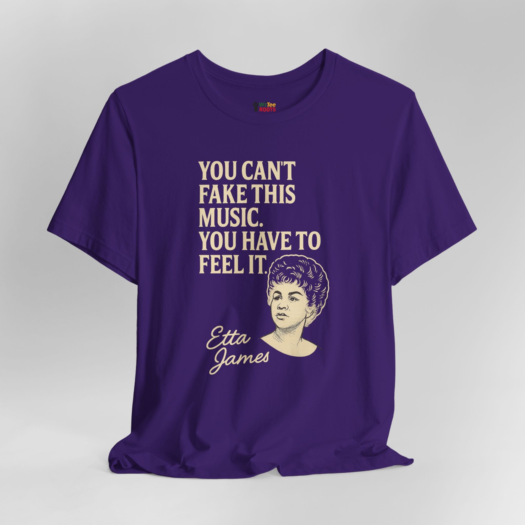 Purple t-shirt with text and a portrait of Etta James on a gray background