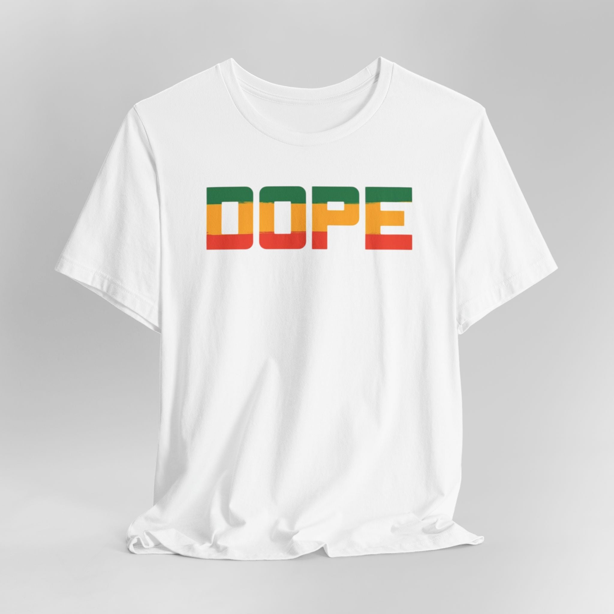 White t-shirt with 'DOPE' in colorful letters on a gray background
