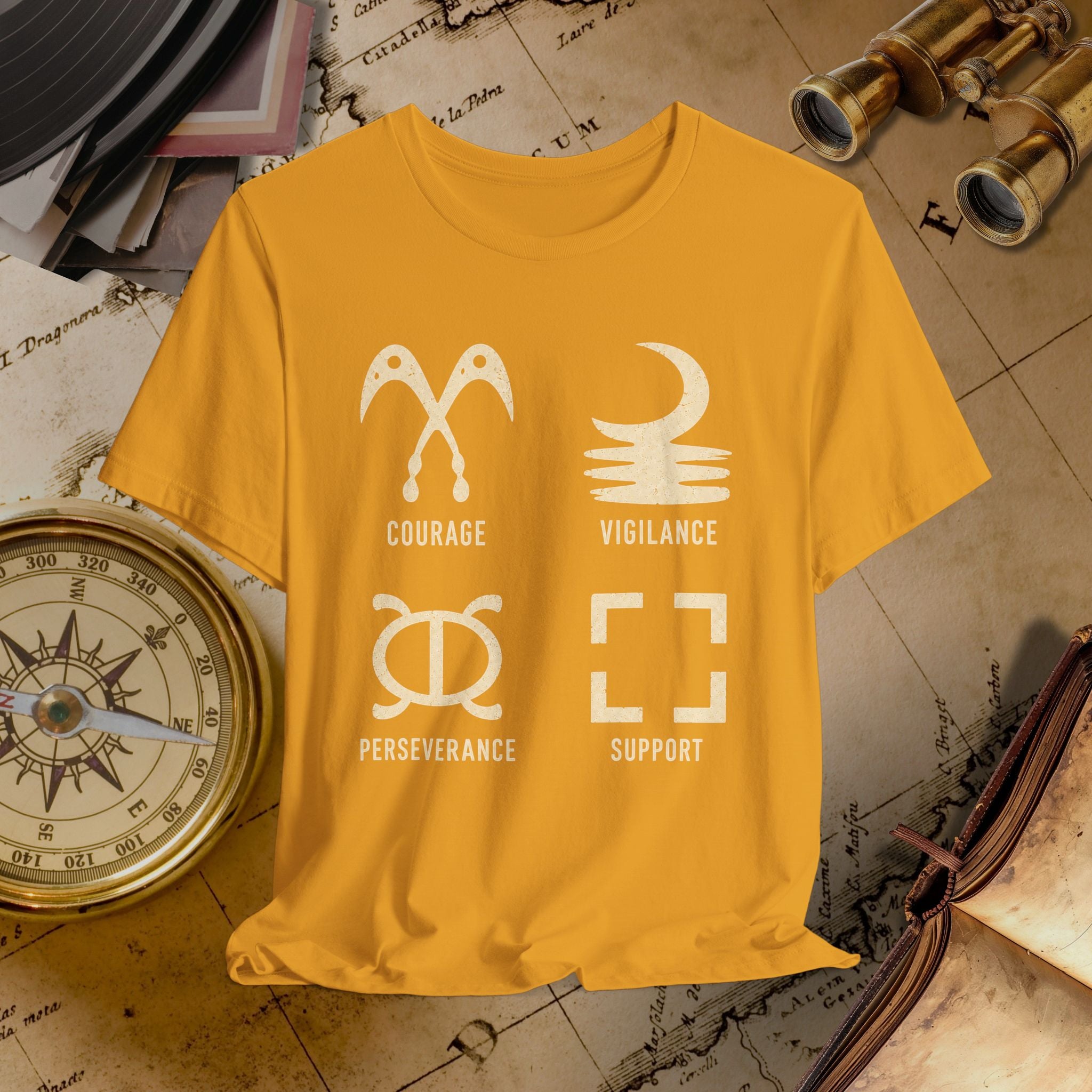 Mustard t-shirt with white symbols and text on a vintage map background
