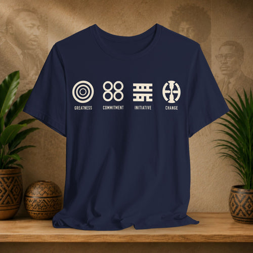 Navy blue t-shirt with white graphics and text on a wooden surface with plants and a textured wall background