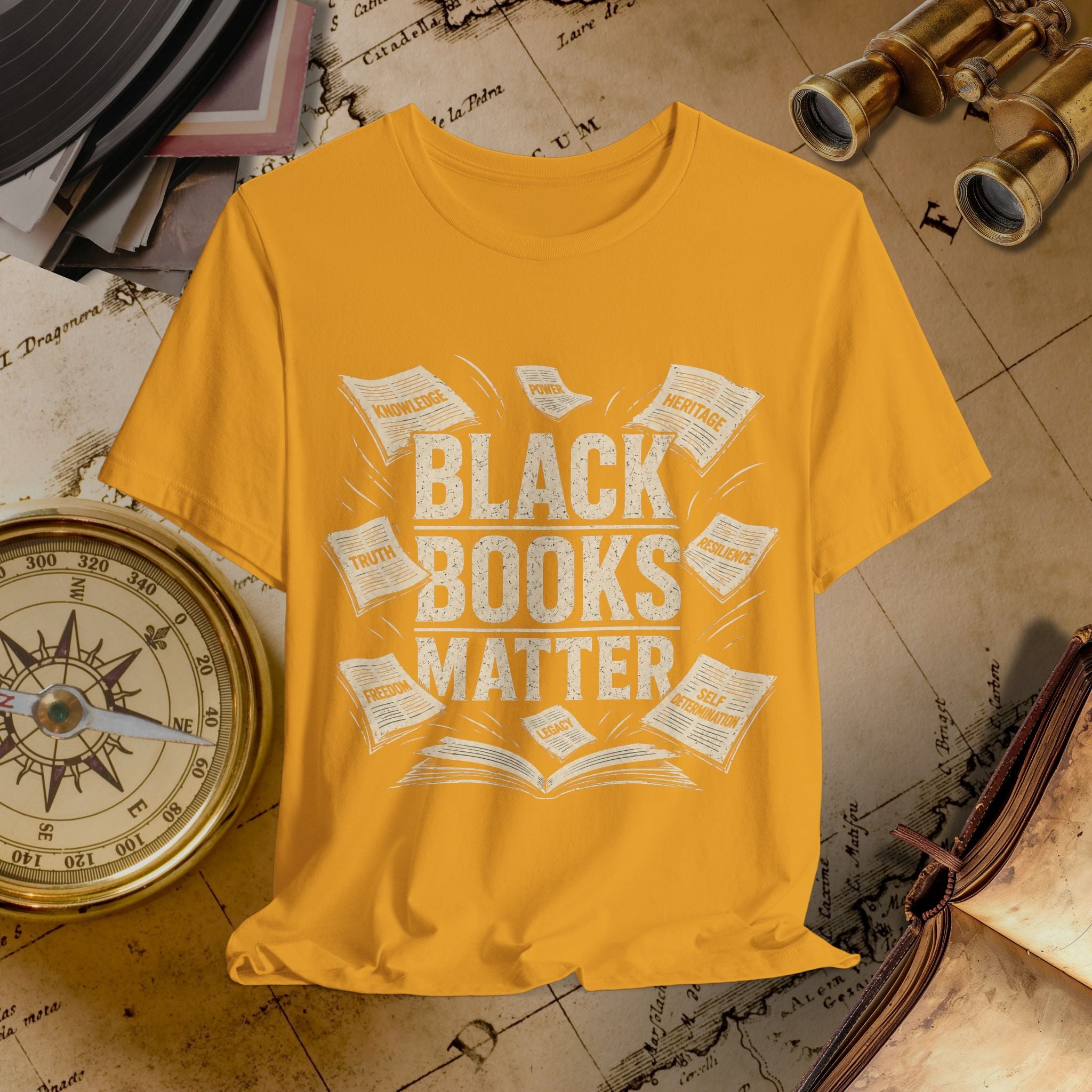 Yellow t-shirt with 'Black Books Matter' text on a vintage map background