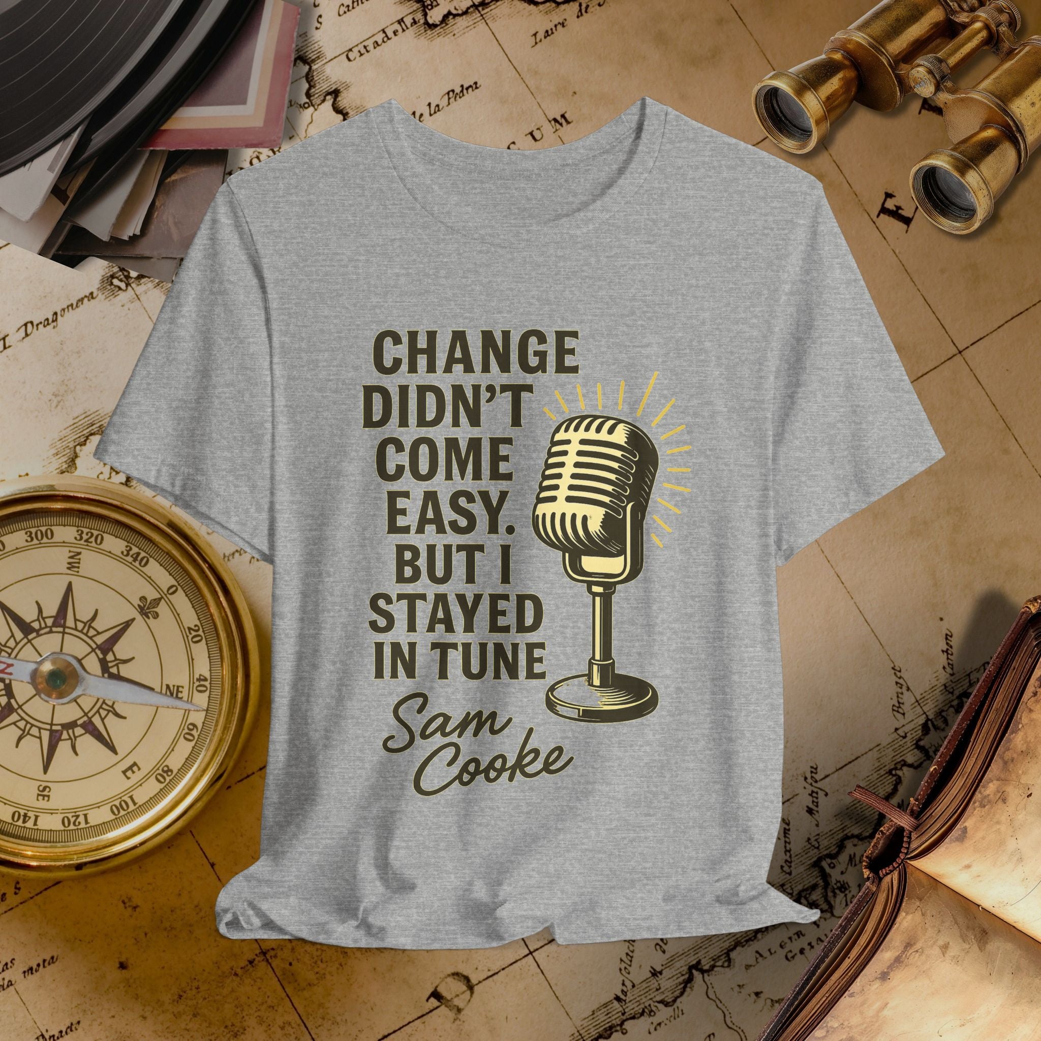 Gray t-shirt with microphone graphic and text on a vintage background