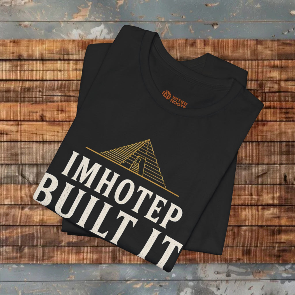 Black t-shirt with 'IMHOTEP BUILT IT' text and pyramid design on a wooden surface