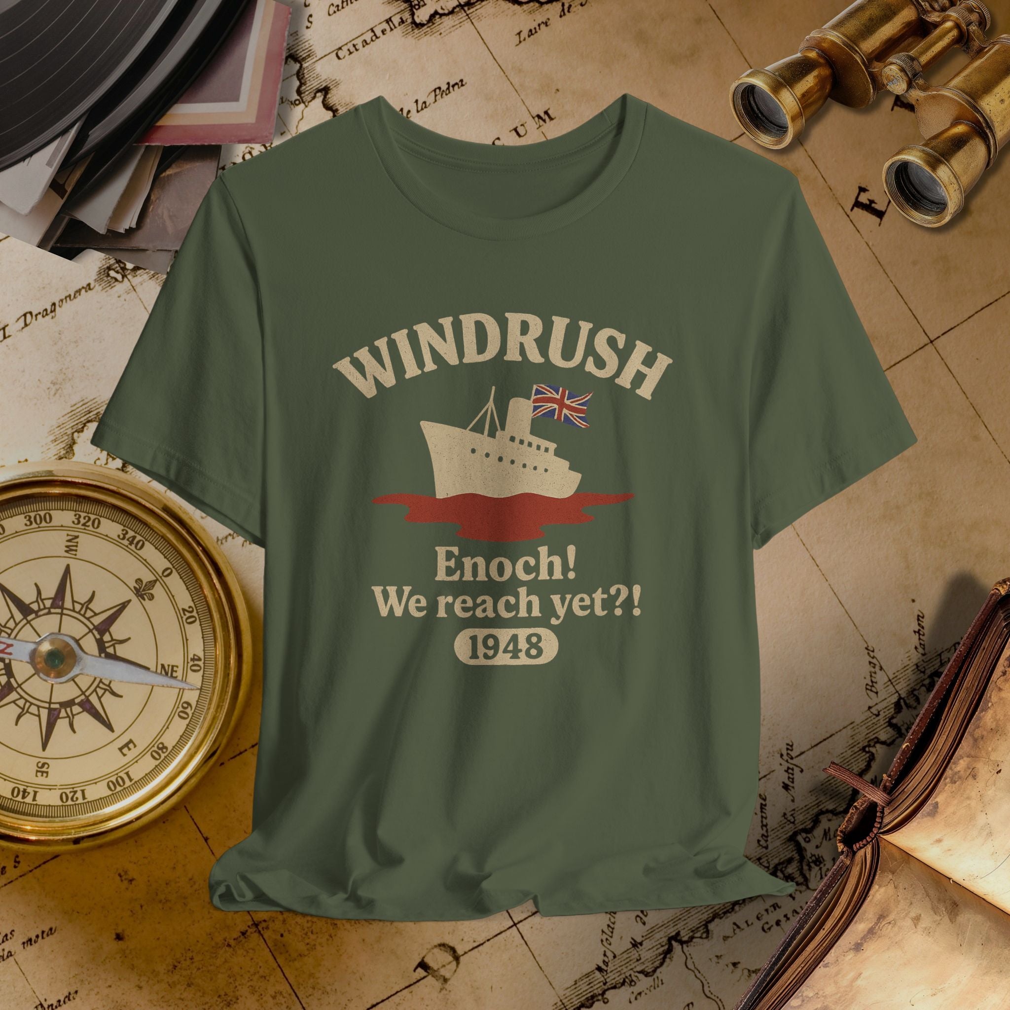 Green t-shirt with 'Windrush' design on a vintage map background